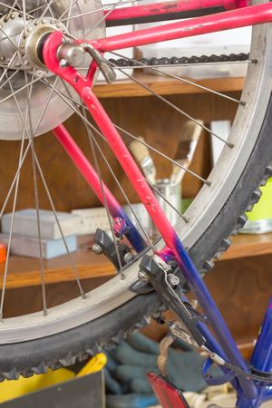 Closeup of bike wheel over workshop table