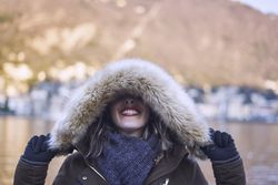 woman covering eyes with a hood
