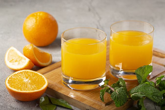 Glass with orange juice on the table.