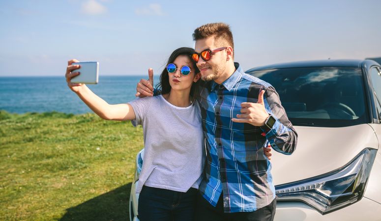 Young couple doing a selfie on the car