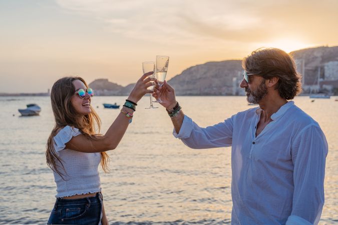 Happy family drinking wine on beach