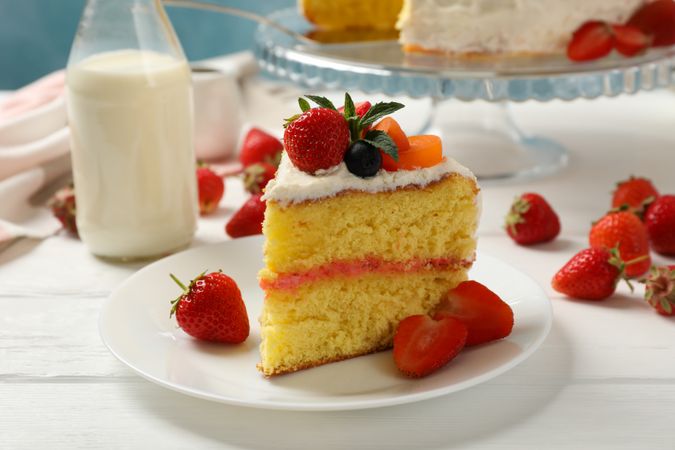 Composition with delicious berry cream cake on wooden table. Tasty dessert