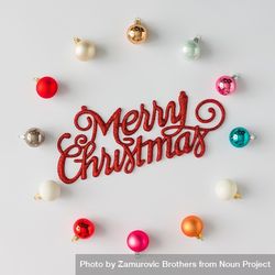 Circular border of colorful Christmas bauble decorations on light background with “Merry Christmas” 0Jgwd5