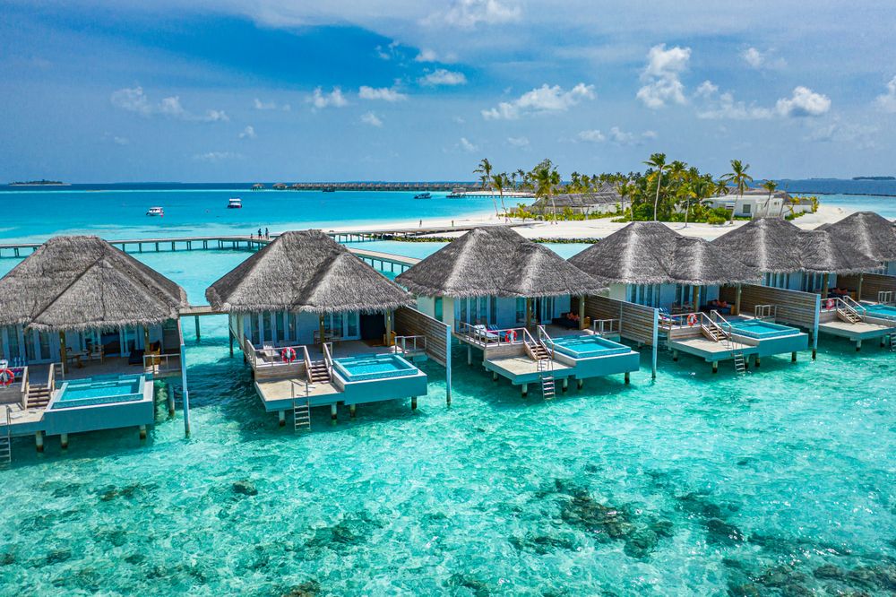 A row of back patios of holiday villas on tropical beach resort