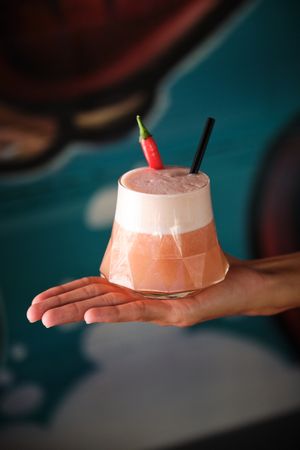Crop person demonstrating spicy cocktail