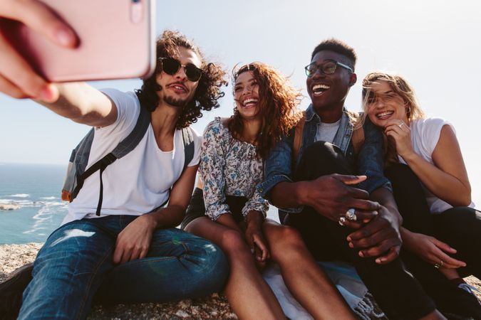 Group of hikers relaxing and taking selfie