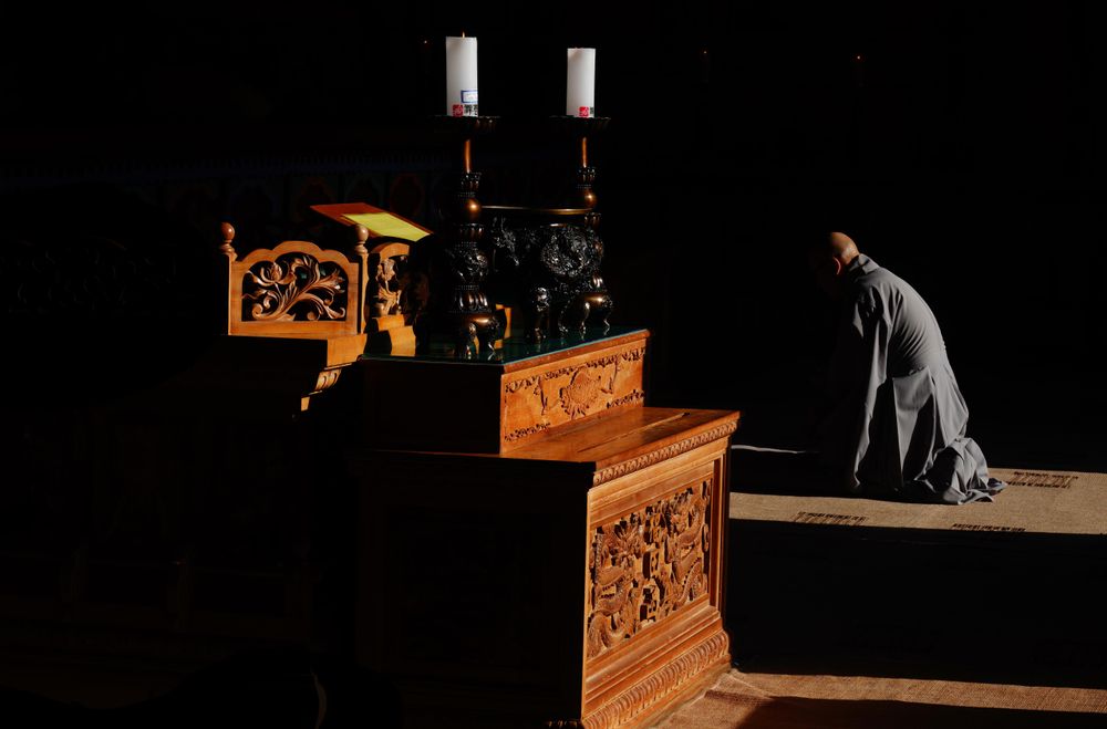 Man praying on floor in a temple