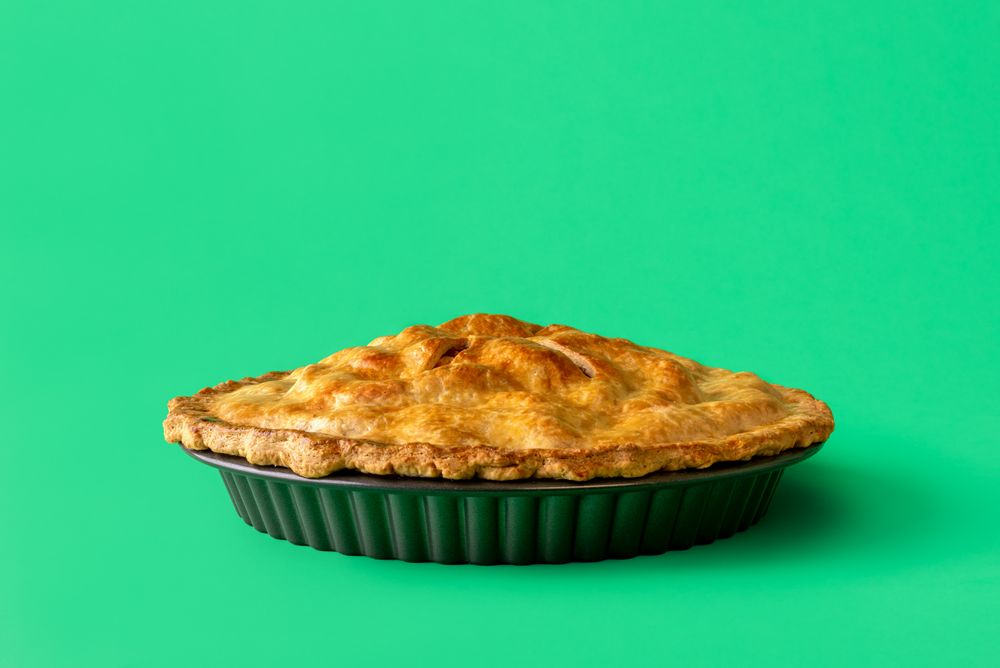 Apple pie close up, minimalist on a green background
