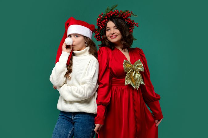 Mum in red dress with gold bow and teen daughter