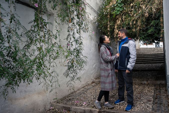 Pleased diverse couple exploring ancient town together