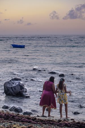 Buckshot of two woman looking out a the Indian Ocean