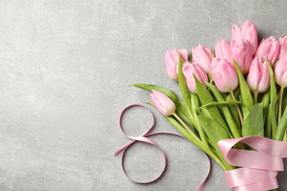 Eight made of ribbon and tulips on grey background, space for text