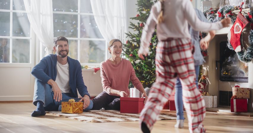 Happy Little Family Exchanging Gifts on Christmas Morning