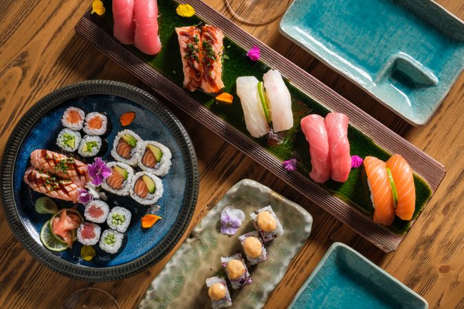 Assorted delicious sushi on wooden table