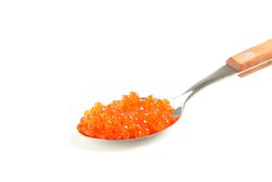 Spoon with red caviar isolated on blank background, closeup