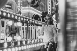 Little girl walking near amusement ride