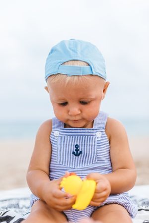Baby boy playing with rubber ducks