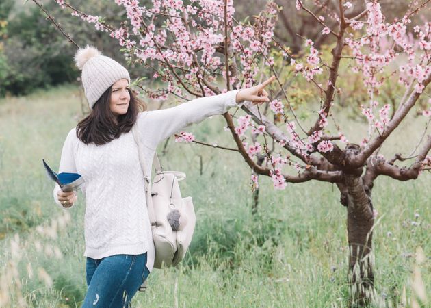 Tourist reading guide in spring countryside