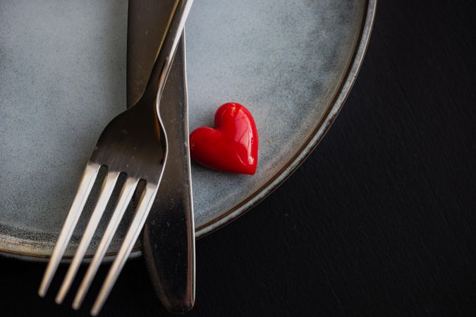 Table setting with heart next to silverware