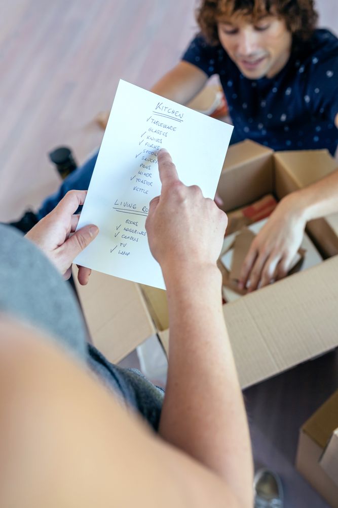 Couple unpacking moving boxes