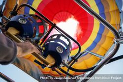 Close up of pilot switching on flame heating hot air balloon before flight 48V6k0