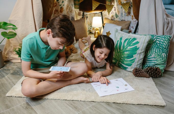 Children playing in a cozy diy tent at home