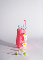 Cute toy of a pink suit case and glasses with daisies