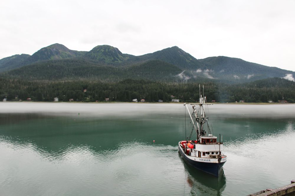 Lake with boat surrounded by hills