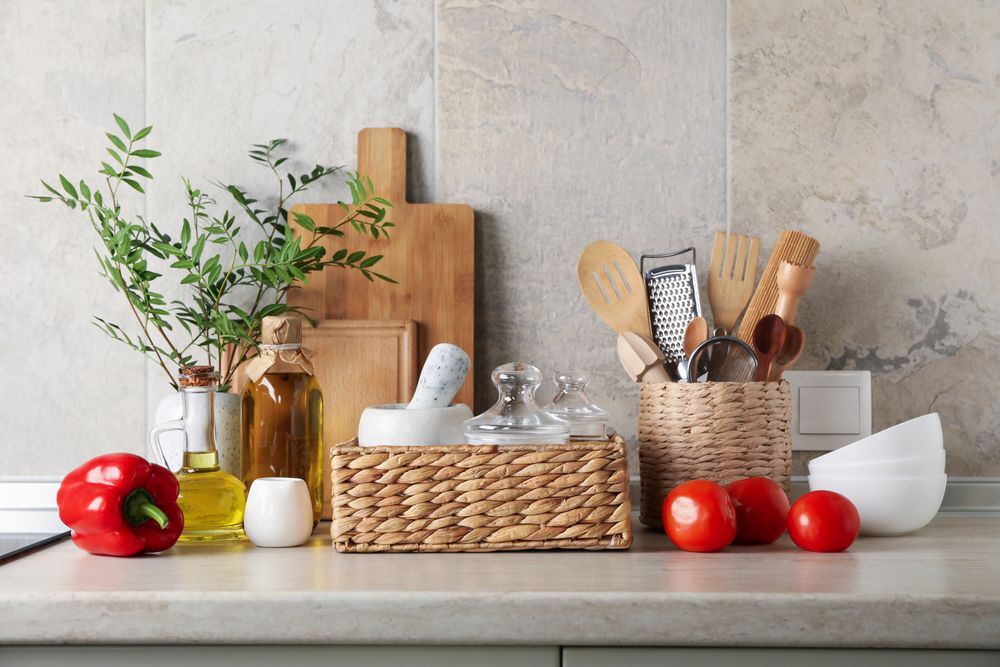 Kitchen table with different supplies and vase with plant