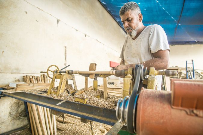 Man using woodworking machine at workplace