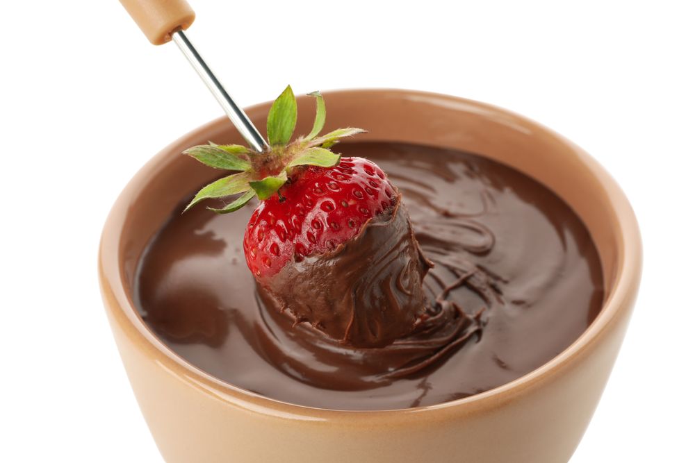 Chocolate fondue. Strawberry in chocolate and bowl isolated on plain background