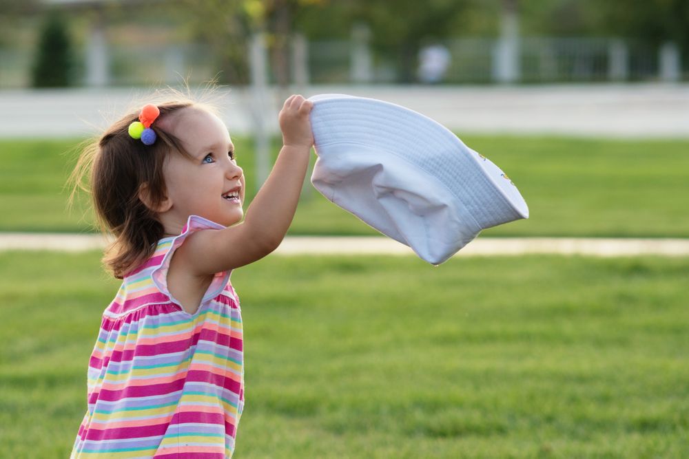 Toddler playing in summer outdoors