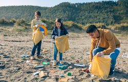 Young volunteers cleaning the beach