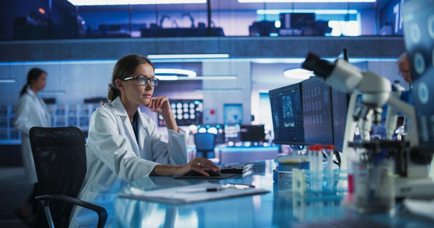 Medical Hospital Research Laboratory: White Female Neurosurgeon Using Computer with Brain Scan MRI Images, Finding Best Treatment for Sick Patient.