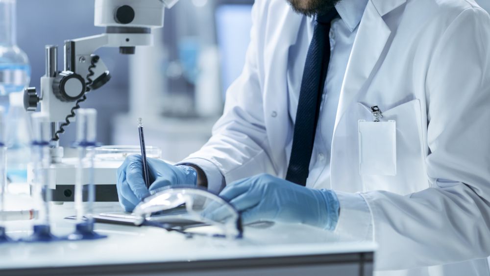 Research Scientist Writes Down Experiment Observations.