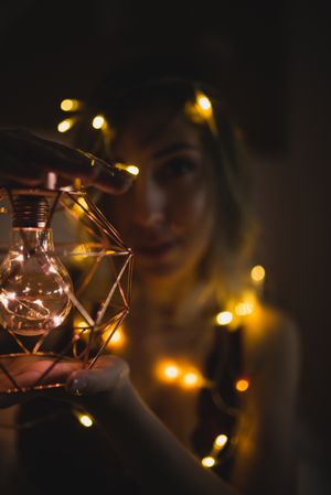Woman surrounded with light garland