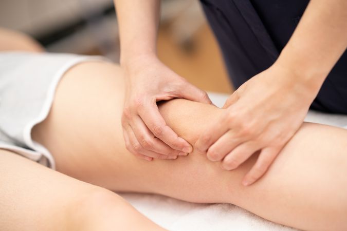 Close up of physio working on female knee