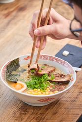 Faceless Client Eating Ramen Soup