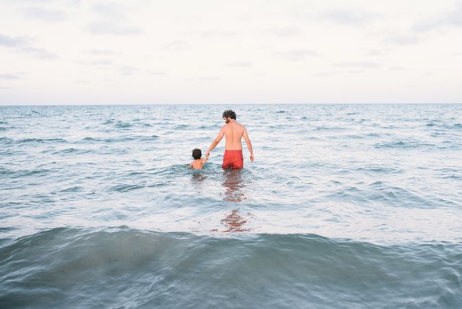 Father with son walking in water