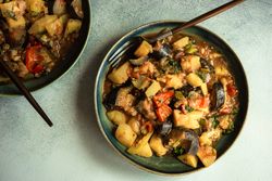 Top view of Georgian summer and autumnal dish Ajapsandali with vegetables on grey counter with copy space