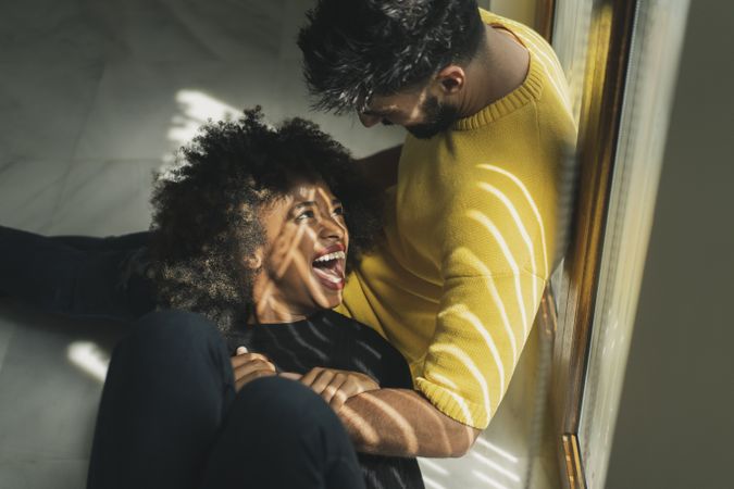 Black woman lying on knees of boyfriend