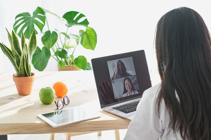 Asian medic consulting patient online in clinic