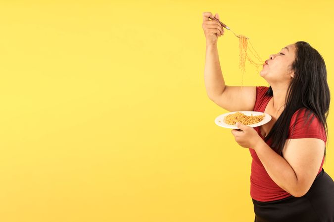 Indonesian Woman Eating Indomie Goreng Instant Noodle