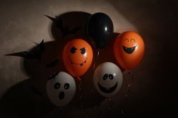 Different balloons on dark background. Halloween concept