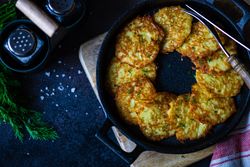 Top view of pan cooking Ukrainian potato pancakes, deruny