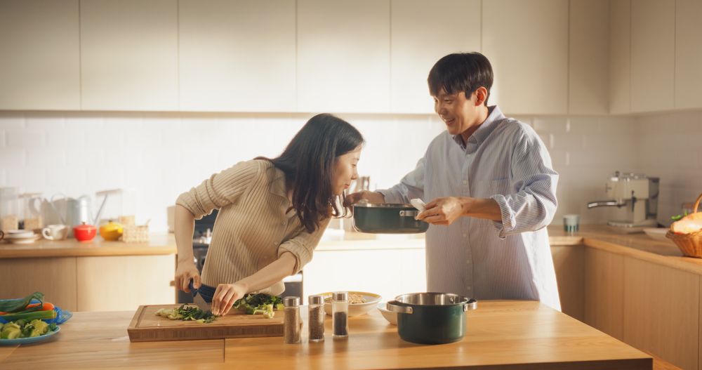 Portrait of a South Korean Young Couple Cooking at Home.