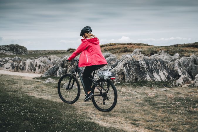 Female cyclist riding on mountain road