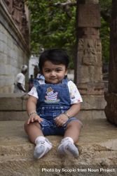 Young Indian child wearing denim sitting on the ground 41kDl0