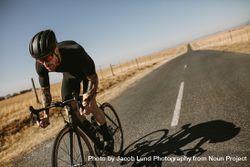 Professional cyclist practising on a long road bDjoL8