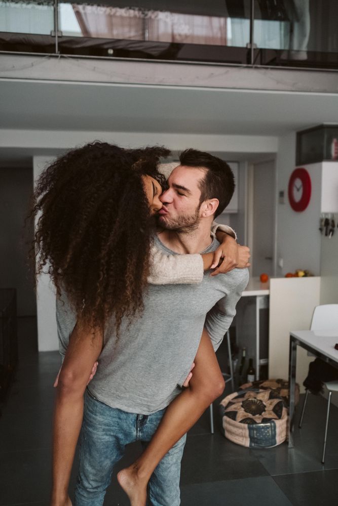 Multiracial couple having fun at home